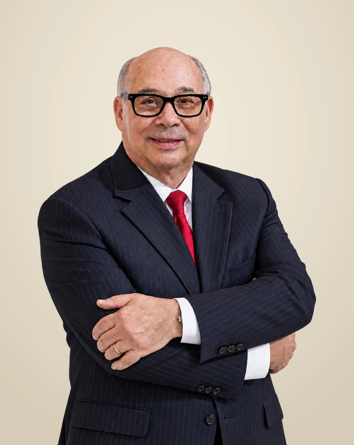 Michael R. Friedberg in a pinstripe suit, arms folded